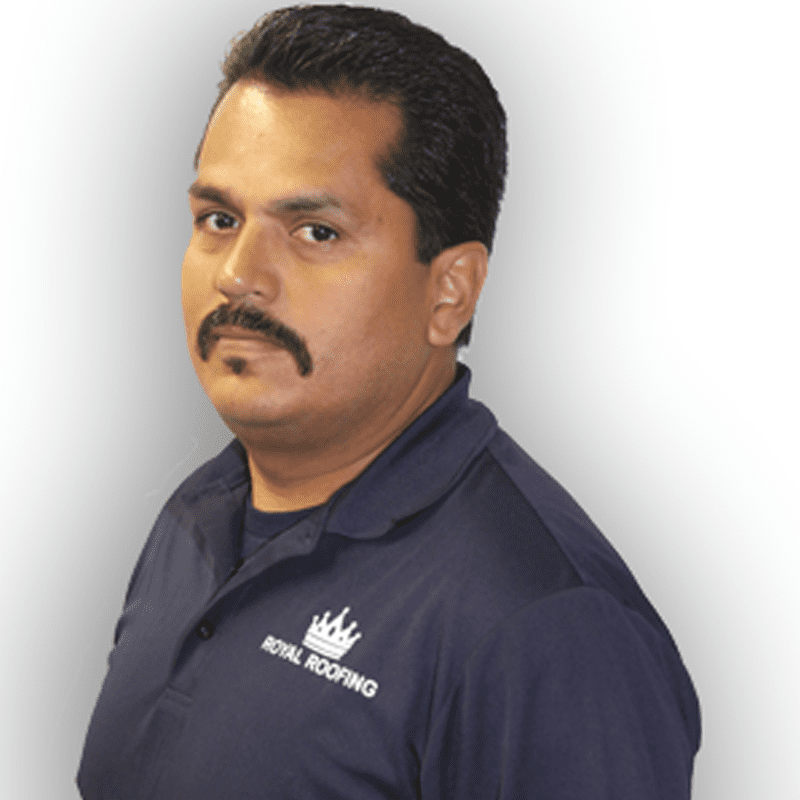 Gilbert Hernandez_WEB A man with a mustache wearing a navy blue "Royal Roofing" polo shirt poses against a light background.